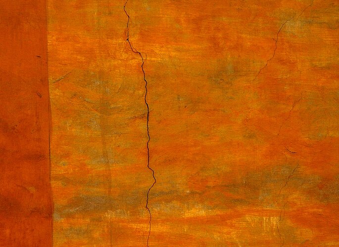 Crack in orange wall